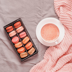 Wall Mural - Bed with pink knitted plaid, coffee and macaroons.