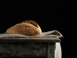 Baked white wheat flour oval crispbread on a wooden board