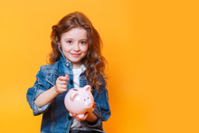 Responsible Girl Putting Money Into Piggy Bank For Future Saving