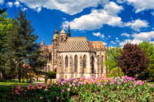 St. Michael Chapel And St. Elisabeth Cathedral In Kosice, Slovakia (Slovensko). Beautiful Daytime Cityscape In Sunlight With Flowers And Blue Sky With Clouds