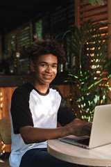 Sticker - Young african teenager student sitting at the cafe