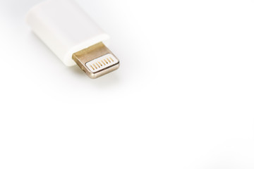 Connector lightning on a white background. This is a proprietary connector used to connect mobile devices to well-known host computers