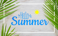 Hello Summer Travel Vacation Concept Flat Lay Poster Background Concept. Hello Summer Text On White Wood Background With Green Nature Tropical Palm Leaf.