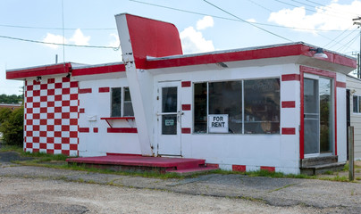 Rundown abandoned red and white roadside diner.