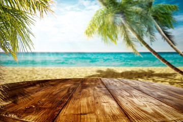 Wall Mural - Summer landscape of beach ocean and palms. Wooden old table of free space for your decoration. 