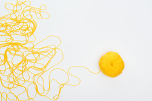 Top View Of Knitting Ball And Yellow Yarn Isolated On White