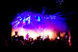 © Eva - Picture of a lot of people enjoying night perfomance, large unrecognizable crowd dancing with raised up hands and mobile phones on concert. nightlife