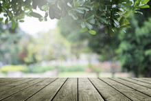 Wooden Table And Blurred Green Nature Garden Background.