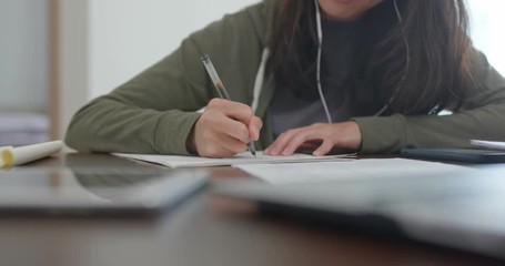 Wall Mural - Woman do revision on the note with cellphone at home