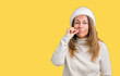 © Krakenimages.com - Beautiful middle age woman wearing winter sweater and hat over isolated background mouth and lips shut as zip with fingers. Secret and silent, taboo talking