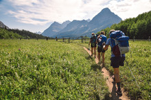 Women Backpacking In Glacier National Park In Montana During Summer