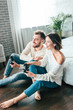 © LIGHTFIELD STUDIOS - happy man and attractive woman playing video game at home