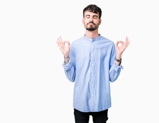 Young handsome business man over isolated background relax and smiling with eyes closed doing meditation gesture with fingers. Yoga concept.