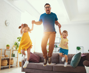 Wall Mural - . Happy father's day! Children congratulates dad a jump and dance  .