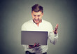 © Feodora - excited man reading great news on his laptop