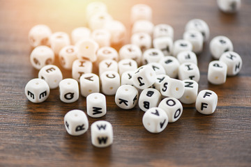 Text dice cube concept Letter dices alphabet on wooden background