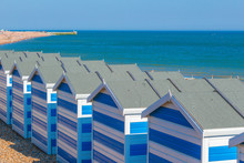 Seaside At Hastings In South East England With Blue And White Striped Beach Cabanas. 
