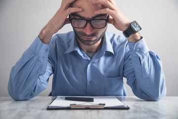 Wall Mural - Caucasian tired businessman at office desk.