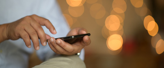 Businessman texting with mobile smart phone at night