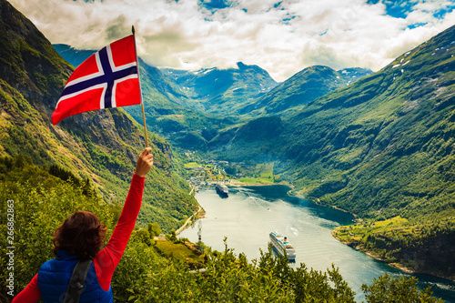 Tourist over Geirangerfjord with norwegian flag Fototapeta
