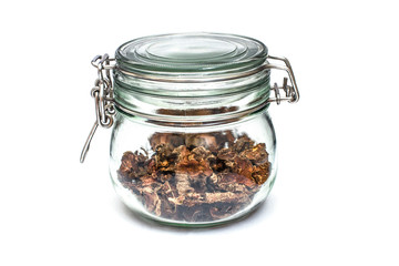 Wall Mural - cut dry root of Rhodiola rosea in a glass jar on natural white background