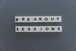 Breakout Sessions word made of square letter word on grey background.