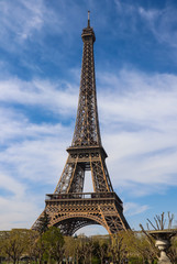 Eiffel Tower in Paris France against blue sky with clouds. April 2019