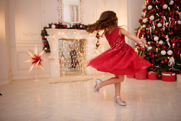 One pretty little girl with blonde hair wearing red, sparkly Christmas dress