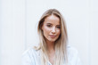 © Drobot Dean - Close up of a smiling young blonde woman standing
