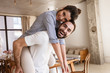 © Drobot Dean - Photo of cute brunette couple in love smiling while hugging together in apartment
