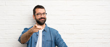 Handsome Man With Beard Over White Brick Wall Points Finger At You With A Confident Expression