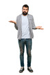 © luismolinero - Handsome man with beard unhappy for not understand something over isolated white background