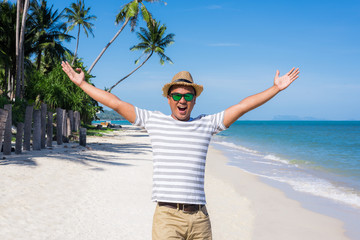 Happy young asian man on beach in vacation time.