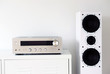 © lial88 - Modern audio stereo system with white speakers on bureau in modern interior