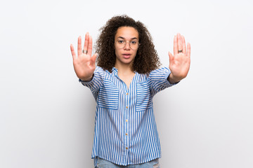 Dominican woman with striped shirt making stop gesture for disappointed with an opinion