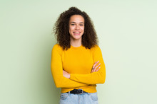 Dominican Woman Over Isolated Green Background Keeping The Arms Crossed In Frontal Position