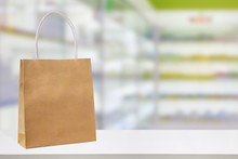 Paper Bag On Pharmacy Drugstore Counter Table With Medicine And Healthcare Product On Shelves Blur Background