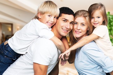 Young  family at home smiling at camera