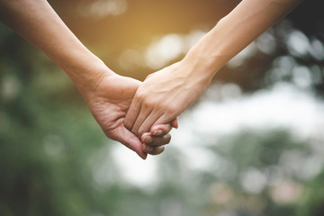 Closeup female holding hand standing and walking on the sidewalk with the lighting on