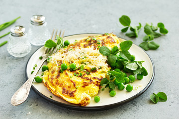 Wall Mural - Breakfast. Frittata Italian omelet with green peas and salad.