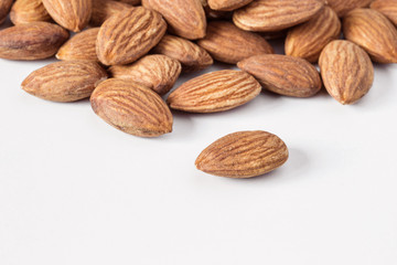 A heap of almonds isolated on white background.