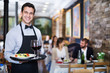 © JackF - Smiling waiter with serving tray in restaurant
