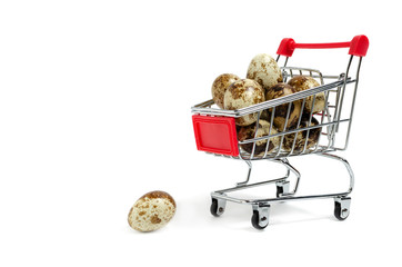 Shopping cart filled with quail eggs on white background.