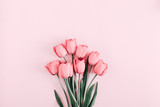 Beautiful composition spring flowers. Bouquet of pink tulips flowers on pastel pink background. Valentine's Day, Easter, Birthday, Happy Women's Day, Mother's Day. Flat lay, top view, copy space
