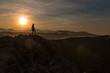© Alberto Menendez/ADDICTIVE STOCK - Silhouette of traveler standing on cliff of seashore against sunset sky, Spain