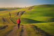 © Alvaro Sanchez/ADDICTIVE STOCK - Back view of man in jacket walking on empty rural road in majestic green fields of Italy