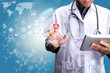 © SOMKID - young doctor with stethoscope and using interface icon