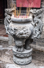 Hong Kong, China - March 8, 2019: Man Mo Yi Tai Taoist Temple In Fu Shin Street. Closeup Of Gray Stone Incense Stick Burning Stand Decorated With Dragons.