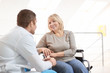 © Africa Studio - Male doctor taking care of mature woman in wheelchair indoors