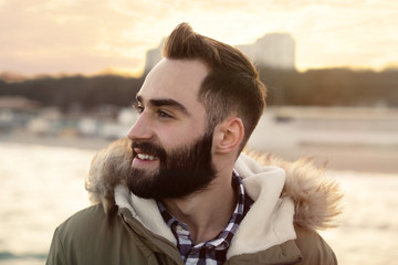 Wall Mural - Portrait of stylish young man near sea